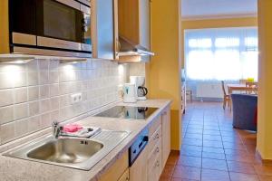 a kitchen with a sink and a counter top at Dünenschloss Dünenschloss 1-16 in Kühlungsborn