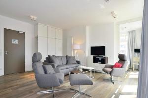 a living room with a couch and two chairs at Aparthotel Anna Düne Aparthotel Anna Düne 2-39 in Wangerooge