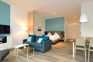 a living room with a couch and a bed at Aparthotel Anna Düne Aparthotel Anna Düne 0-07 in Wangerooge