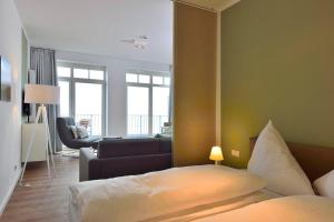 a hotel room with a bed and a living room at Aparthotel Anna Düne Aparthotel Anna Düne 1-23 in Wangerooge