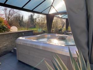 a jacuzzi tub sitting under a tent at Les Rives des Habsbourg in Ensisheim