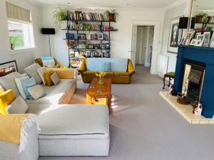 a living room with couches and a fireplace at Eastfield in Edinburgh