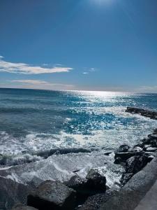 a view of the ocean with rocks and water at Oltre Mare in Sori