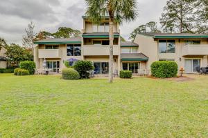 a large house with a palm tree in the yard at Stoney Creek 272 in Hilton Head Island