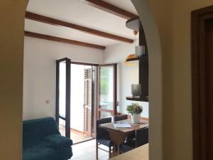 a living room with a blue couch and a table at Villa Conte in Korčula