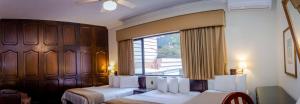a hotel room with two beds and a window at Best Western Plus Hotel Stofella in Guatemala +65 photos