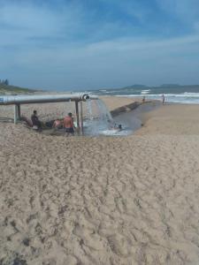 a group of people playing on the beach at Paraíso dos Accácio in Balneario Barra do Sul