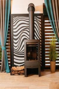 a fireplace in a living room with blue curtains at CHALET NEBO in Bukovel