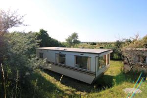 a tiny house in the middle of a field at Bungalow, Adler am See in Zirkow