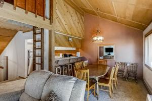 a living room and kitchen with a table and a couch at Living Pines Condominium in Shaver Lake