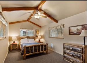 a bedroom with a bed and a ceiling fan at Southfork Lodge Cabin 2 in Lowman