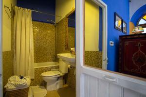 a bathroom with a toilet and a sink at Hotel Casa Miguel in Chefchaouen