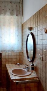 a bathroom with a sink and a mirror at A CASA DI GEMMA in Bologna