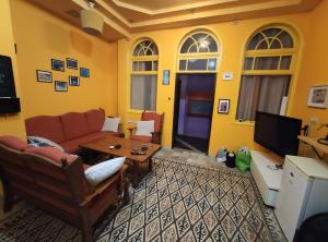 a living room with a couch and a table at Nest House Haifa in Haifa