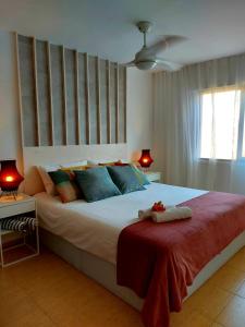 a bedroom with a large bed with a red blanket at Duplex with sea views, garden and terrace in Santa Cruz de Tenerife