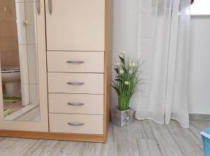 a tall dresser with a mirror in a bathroom at Rooms Mali Raj in Zaton