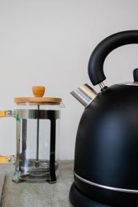 a black tea kettle sitting on top of a counter at Avodation in Walvis Bay +19 photos