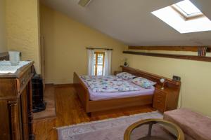 a bedroom with a bed and a skylight at Haus Falkenhof in Knüllwald