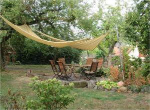 a hammock hanging over a table and chairs in a garden at Haus Falkenhof in Knüllwald