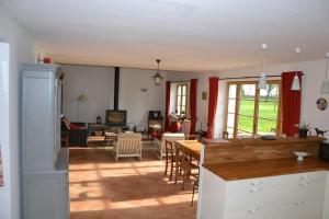 a kitchen and living room with a table and chairs at Domaine d'Antigneul in Bours