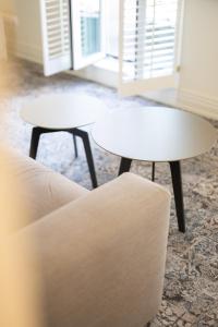 a white coffee table and two chairs in a living room at VIZUALIZA Residence Hotel in Plovdiv