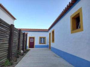 a hallway of a house with a fence at Casa do Páteo in Vila Nova da Baronia