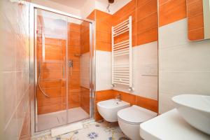 a bathroom with a shower and a toilet and a sink at Casale Guarracino in Sant'Agnello