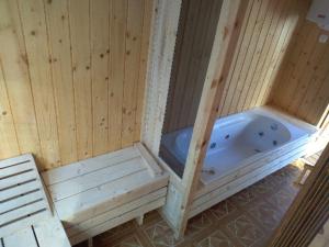 a sauna with a tub and a chair in it at Agroturystyka u Wioli i Irka , apartament u Beaty in Karsin
