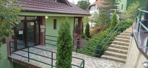 a stairway leading to a house with a door at Apartman Kata in Zlatibor