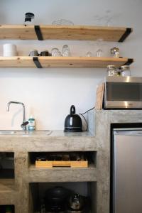 a kitchen with a counter top with a microwave at Avodation in Walvis Bay