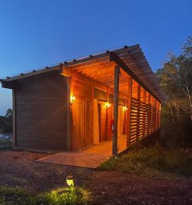 a small cabin with a wooden deck at dusk at Naturluxe & Stars in Watkins Glen