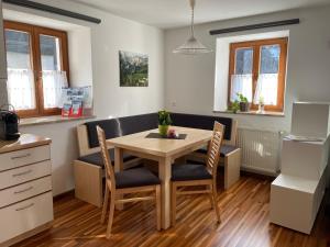 a kitchen and dining room with a table and chairs at Apartment Krämerhaus Annaberg, Dachstein West in Annaberg im Lammertal