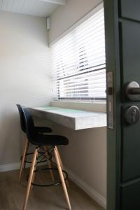 a desk in a room with a chair next to a window at Avodation in Walvis Bay