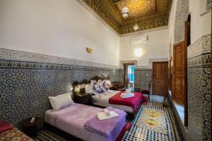 Postel nebo postele na pokoji v ubytování Riad Fes Iline