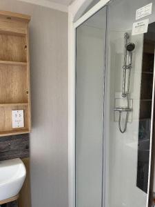 a shower in a bathroom with a toilet and a sink at Swift Bordeaux in Dunoon