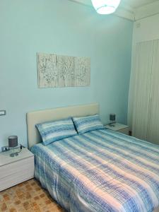a bedroom with a bed with blue walls at Villa Maria - Family House in Monte di Procida