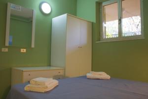 A bed or beds in a room at Villaggio La Perla