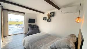 a bedroom with a bed sitting on the floor at Mini villa chaleureuse avec vue mer imprenable in San-Nicolao