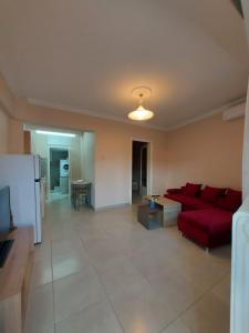 a living room with a red couch and a table at Dream in Kavala 2020 renovated, sunny apartment in Kavála