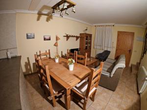 a dining room with a wooden table and a couch at Casa Rural Guadiela in San Pedro Palmiches +18 photos