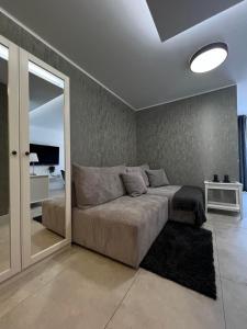 a bedroom with a large bed and a mirror at Pobierowo - Baltic Apartments in Pobierowo
