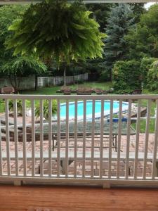 a white fence in front of a swimming pool at The White House Inn in Cooperstown