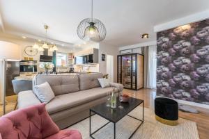 a living room with a couch and a table at Apartment Emma with sauna in Zagreb