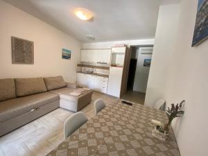 a living room with a couch and a table at Apartments Nautica in Novi Vinodolski