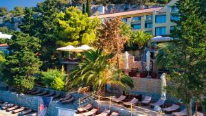 a resort with lounge chairs and a swimming pool at Hotel Podstine in Hvar