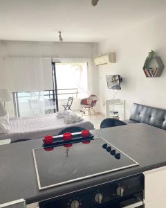 a kitchen with a stove with four baseball bats on it at Krasas Beach Apartments in Larnaka