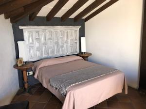 a bedroom with a bed with a white headboard at Spa La Cueva del Agua in Hita +50 photos