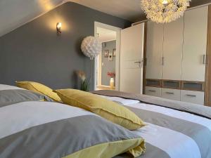 a bedroom with two beds and a chandelier at Apartment in Schauenstein - Franken 40833 in Schauenstein