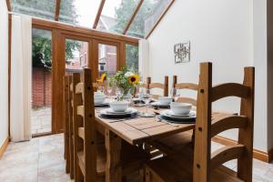 a dining room with a wooden table with chairs at Albert - 5 Bedrooms Sleeps 11 Parking Wi-Fi Contractors in Preston