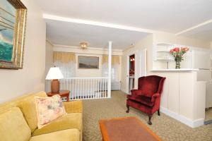 a living room with a couch and a chair at Yankee Peddler Inn in Newport